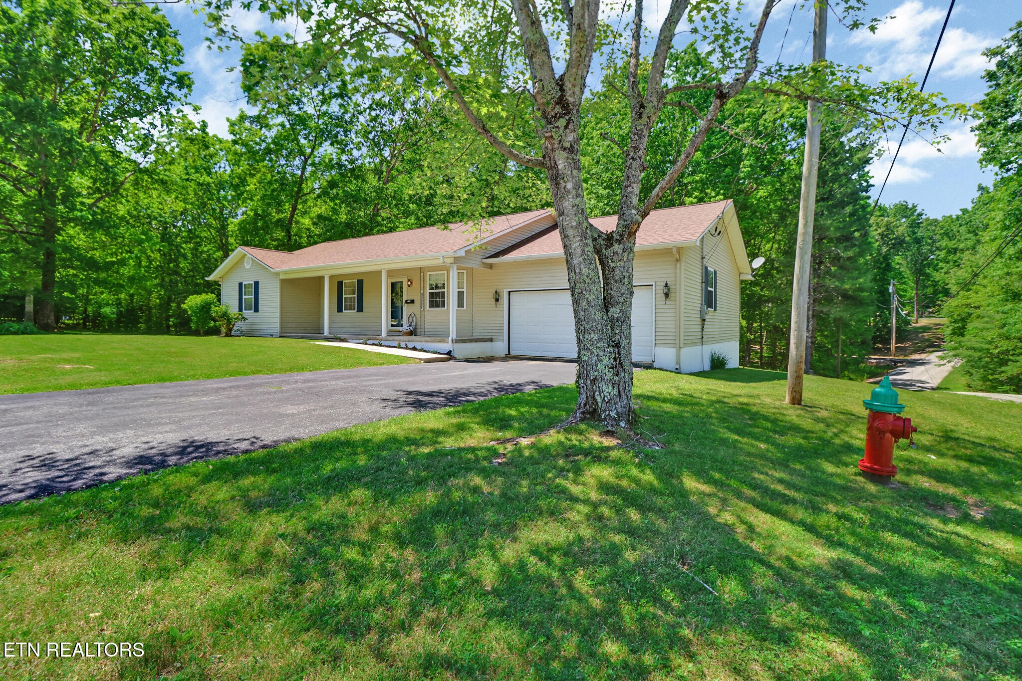 2162 Spruce Loop Crossville, TN 38555 - Photo 2 of 25 a front view of a house with a yard and green space