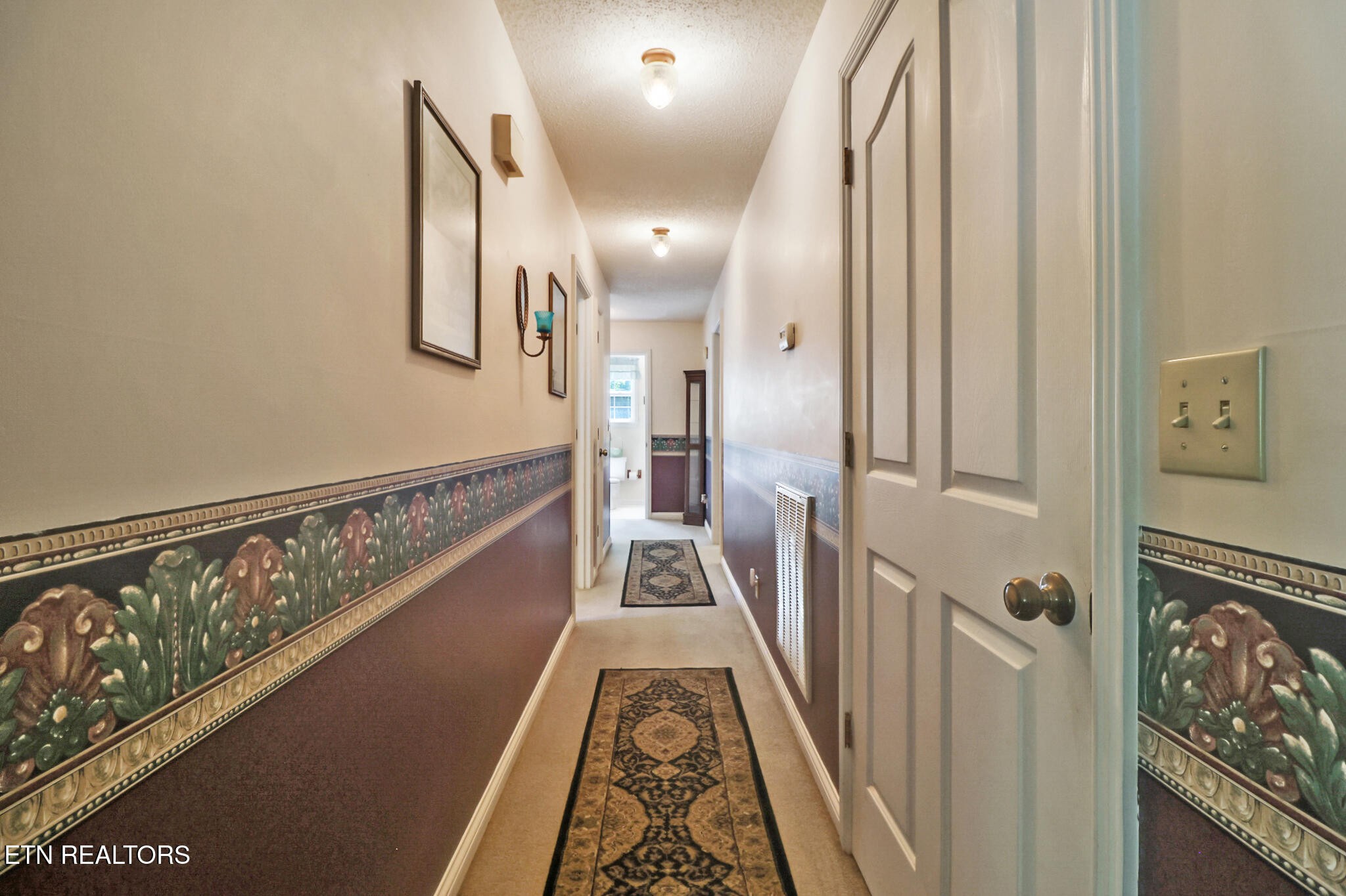 2162 Spruce Loop Crossville, TN 38555 - Photo 21 of 25 a view of a hallway with wooden floor and staircase