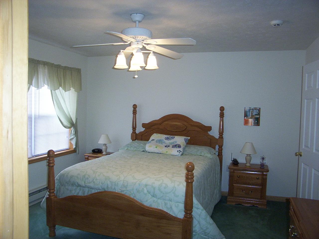 14 Fern Ridge Road Blakeslee, PA 18610 - Photo 5 of 6 a bedroom with a bed and a chandelier