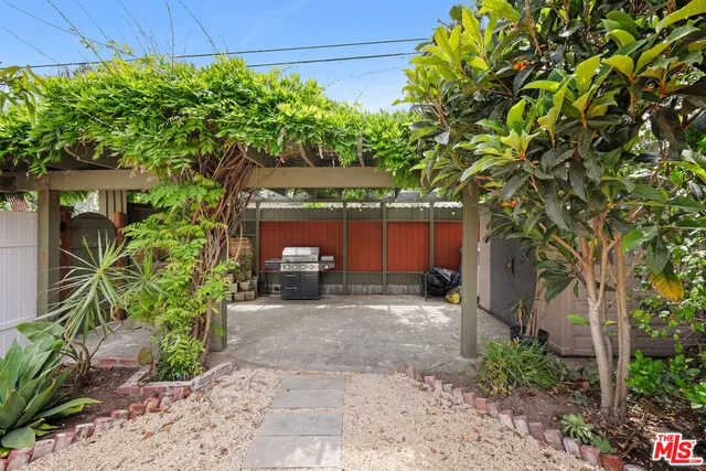 a view of a house with a small yard and plants