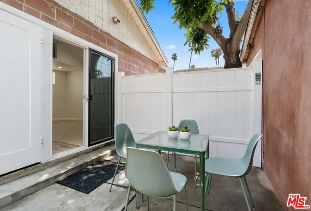a view of a chair and table in the balcony