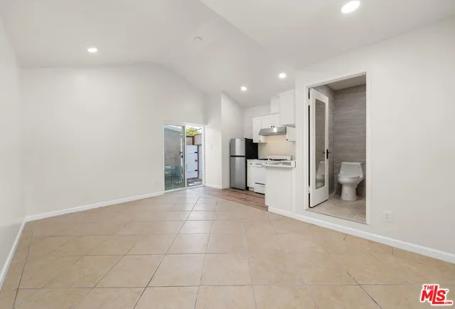 a view of a kitchen with a sink and refrigerator
