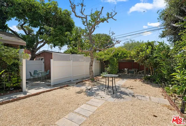a view of a chair and table in the backyard