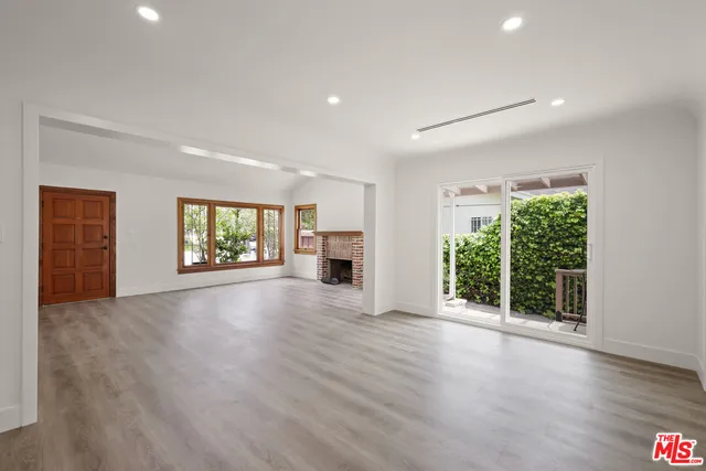 an empty room with windows and yard