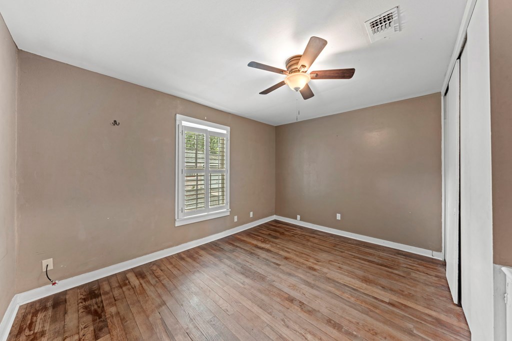 616 Lois Street Kerrville, TX 78028 - Photo 11 of 32 a view of empty room with wooden floor and fan