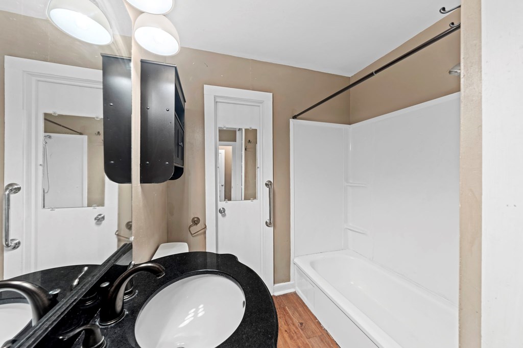 616 Lois Street Kerrville, TX 78028 - Photo 12 of 32 a bathroom with a granite countertop sink and a mirror