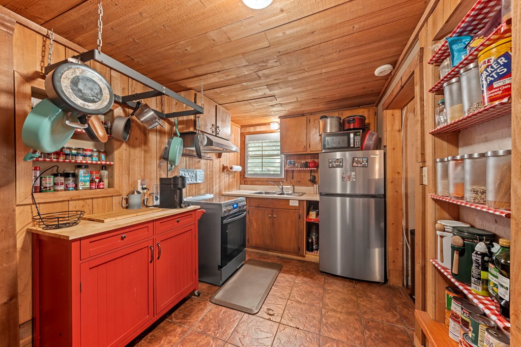 616 Lois Street Kerrville, TX 78028 - Photo 26 of 32 a kitchen with stainless steel appliances granite countertop a refrigerator and a stove top oven