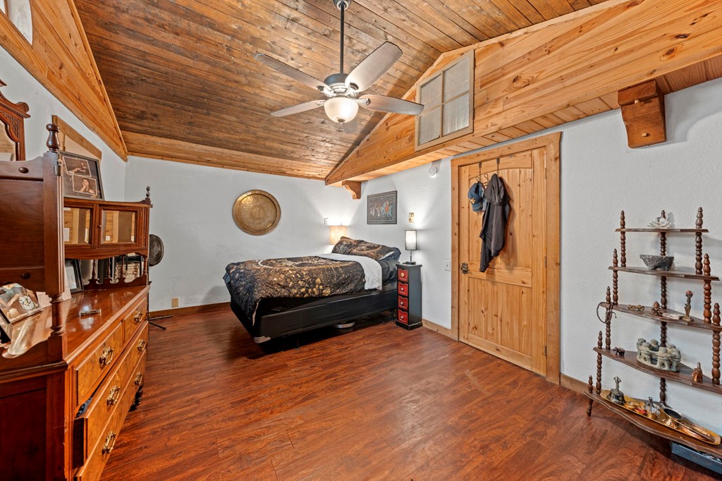 616 Lois Street Kerrville, TX 78028 - Photo 28 of 32 a bedroom with furniture and wooden floor