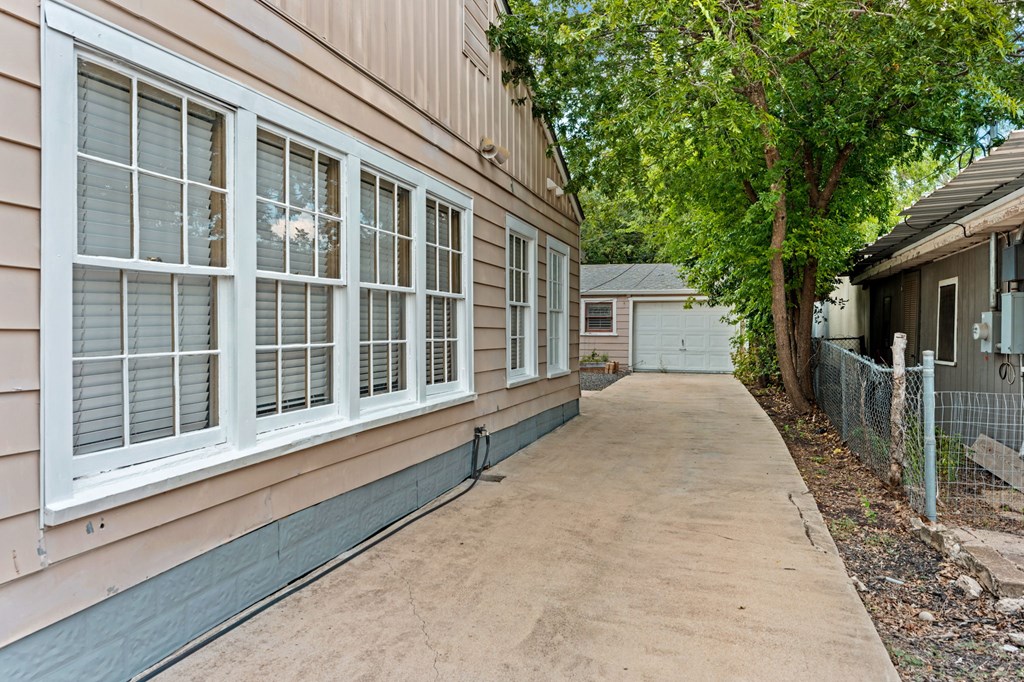 616 Lois Street Kerrville, TX 78028 - Photo 32 of 32 a view of house with a large window and wooden fence