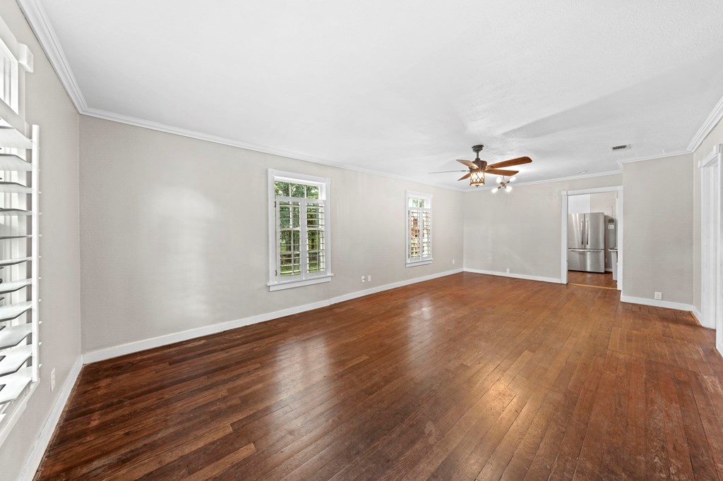 616 Lois Street Kerrville, TX 78028 - Photo 6 of 32 a view of empty room with wooden floor and fan