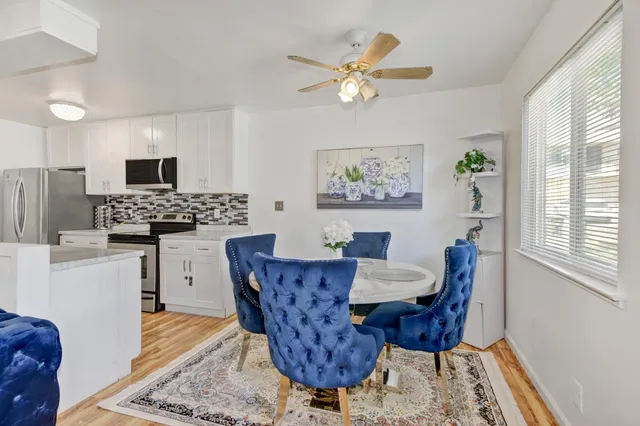 a living room with furniture a dining table and a window