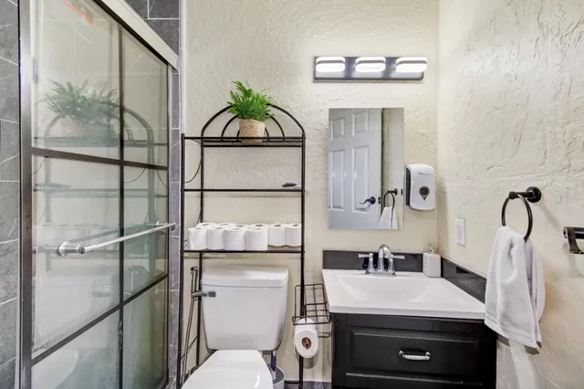a bathroom with a sink toilet and mirror