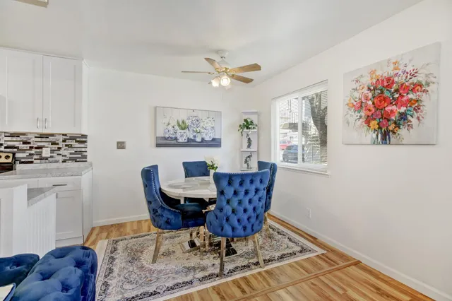 a dining room with furniture a rug and wooden floor