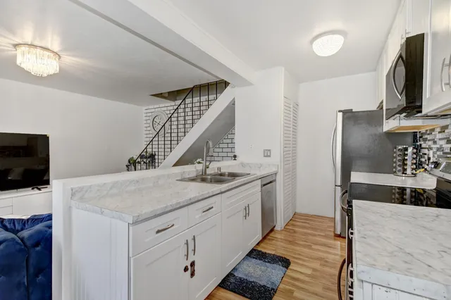a kitchen with a sink and a refrigerator