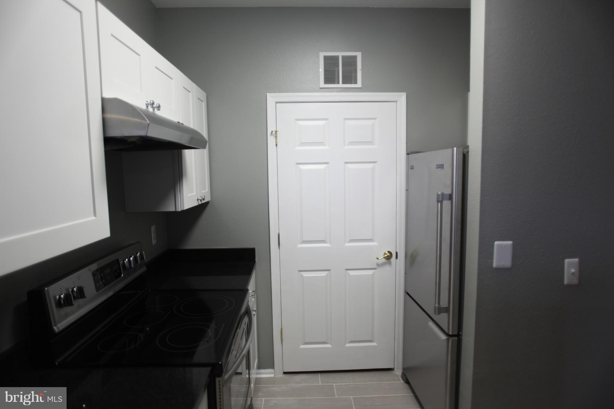 1521 Spring Gate Dr., Unit 10202 McLean, VA 22102 - Photo 18 of 30 Kitchen has attached room with washer and dryer