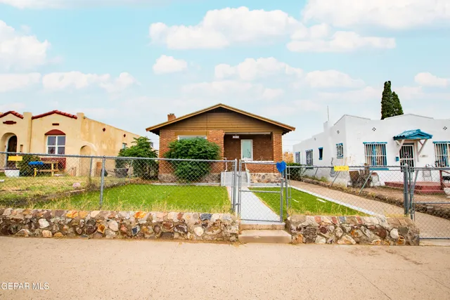 a view of a house with swimming pool and sitting area
