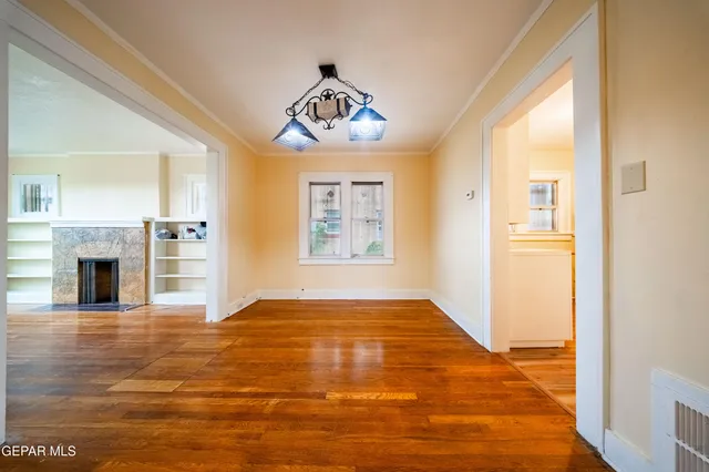 a view of an empty room with a fireplace and a window
