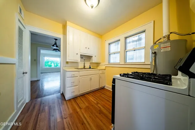 a kitchen with sink cabinets and wooden floor