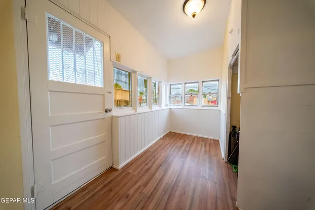a view of a kitchen with wooden floor and windows