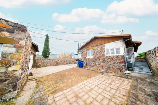 a view of a house with a yard and pathway