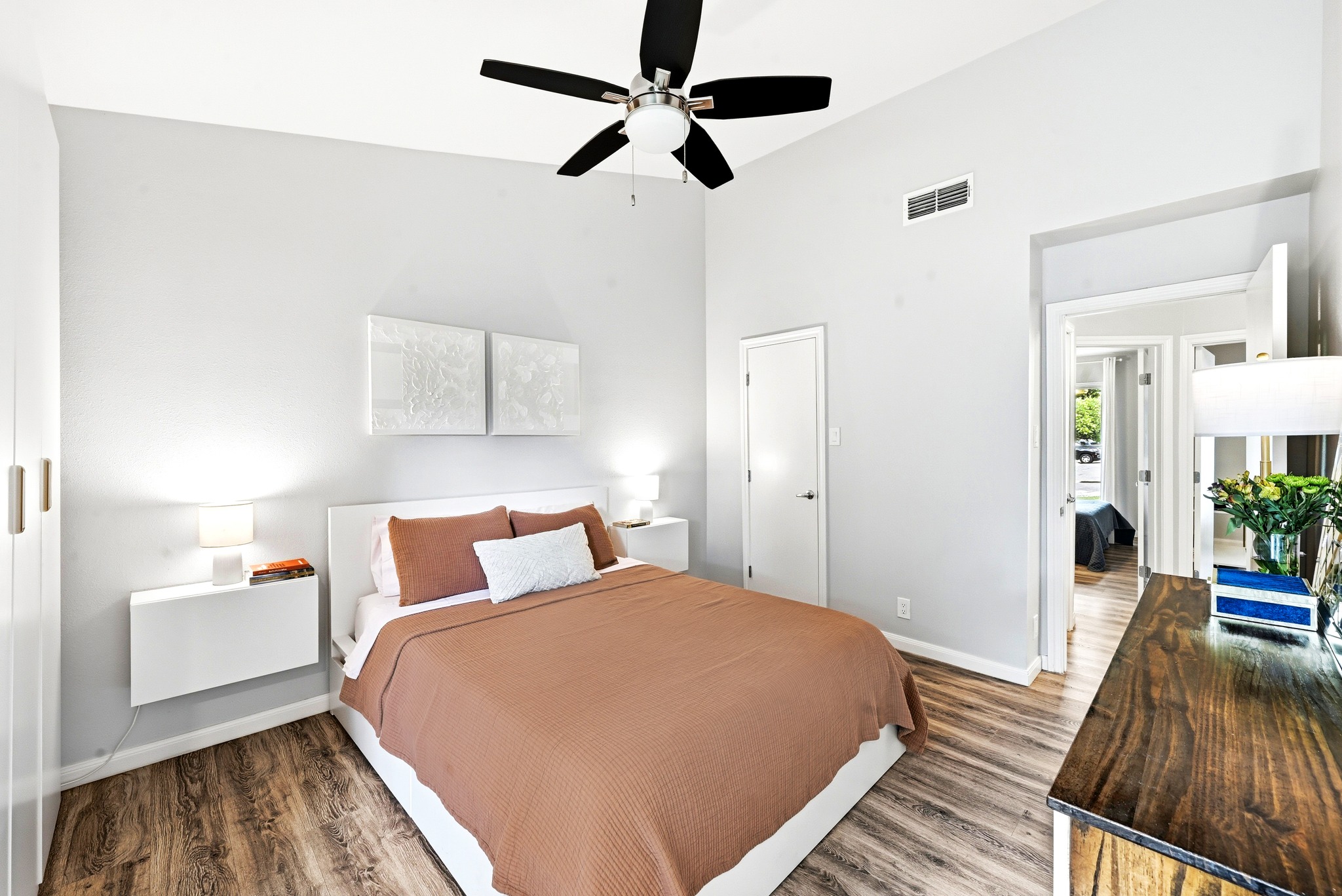7110 Windrift Way Austin, TX 78745 - Photo 16 of 30 A well-appointed bedroom features soaring ceilings and durable wood-look flooring.