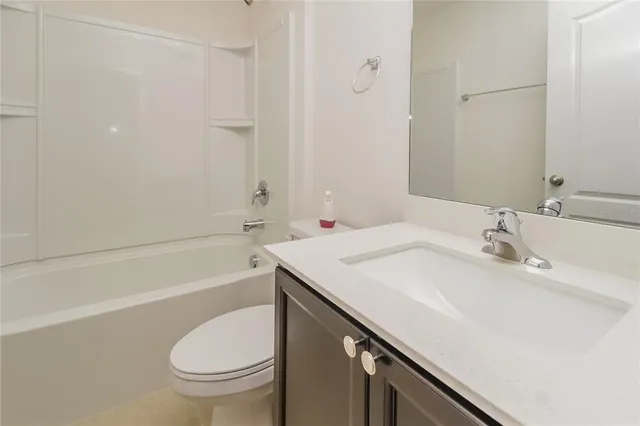 a bathroom with a sink a toilet and bathtub