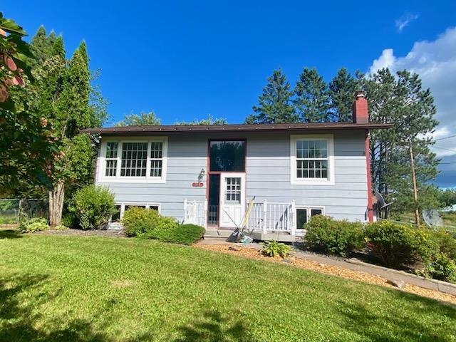 Split foyer home featuring a chimney
