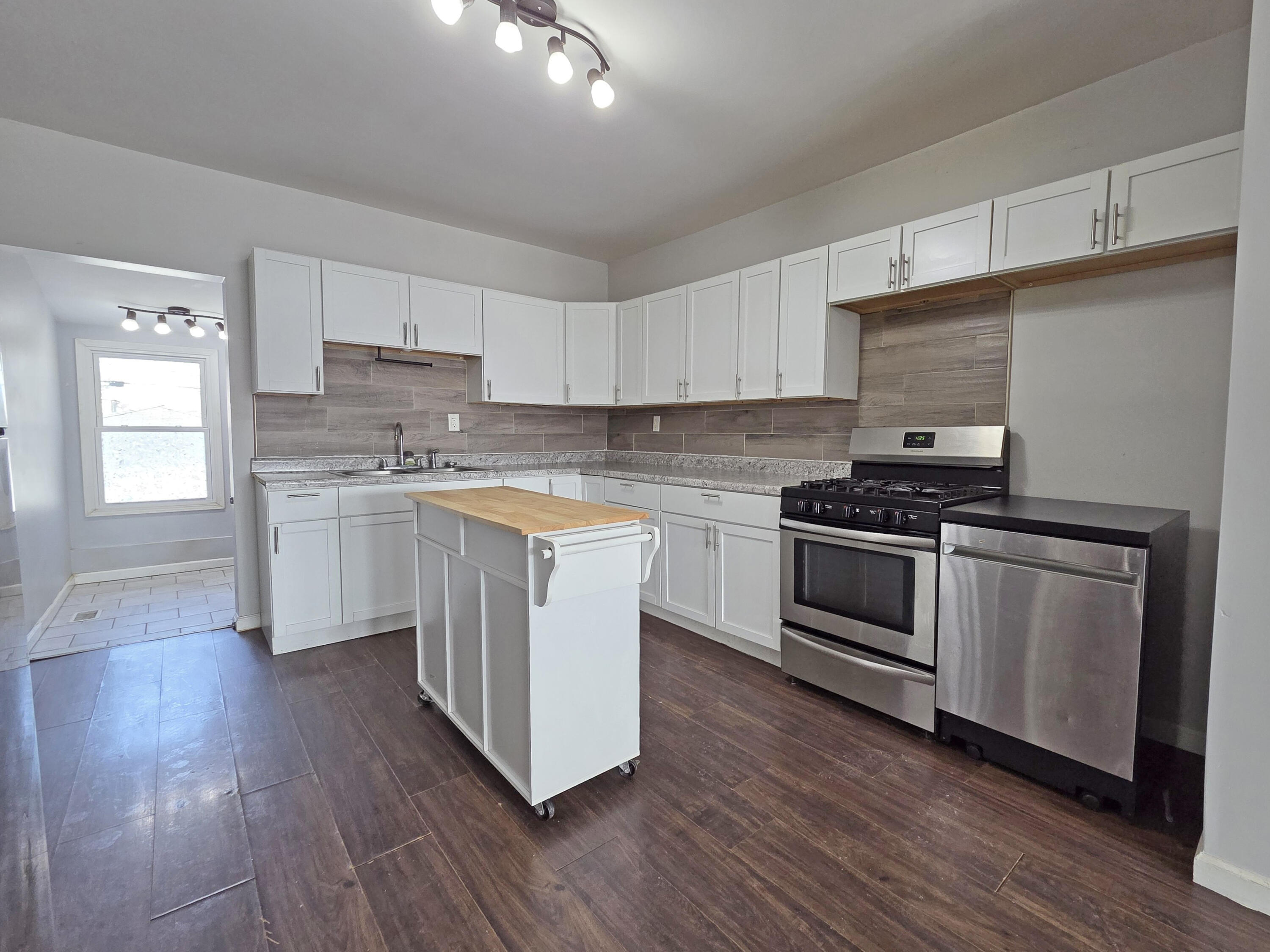 1127 164th Place Hammond, IN 46320 - Photo 12 of 34 a kitchen with granite countertop a sink cabinets and stainless steel appliances