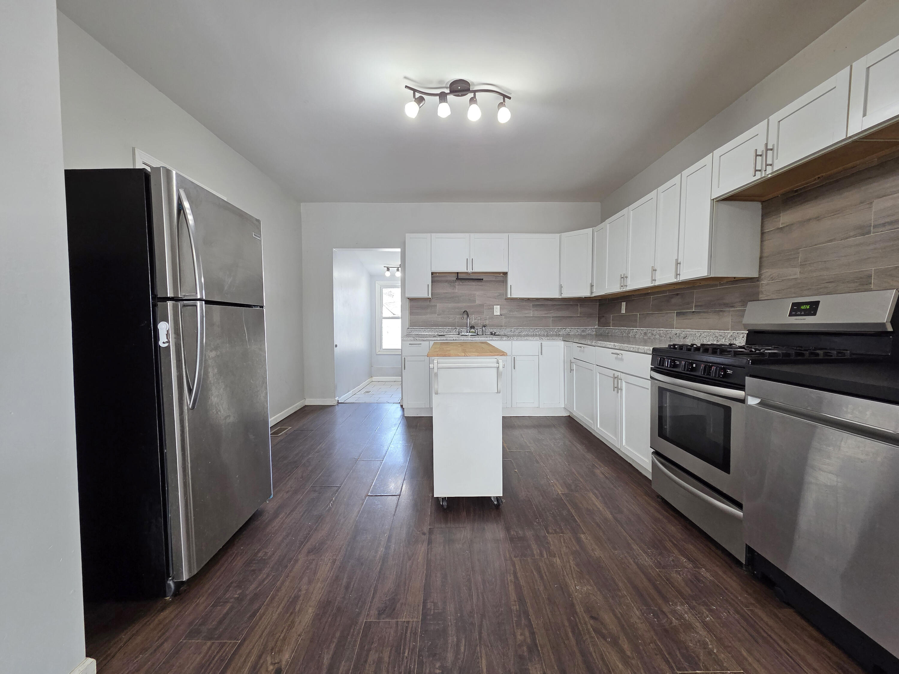 1127 164th Place Hammond, IN 46320 - Photo 13 of 34 a kitchen with a refrigerator and a stove top oven