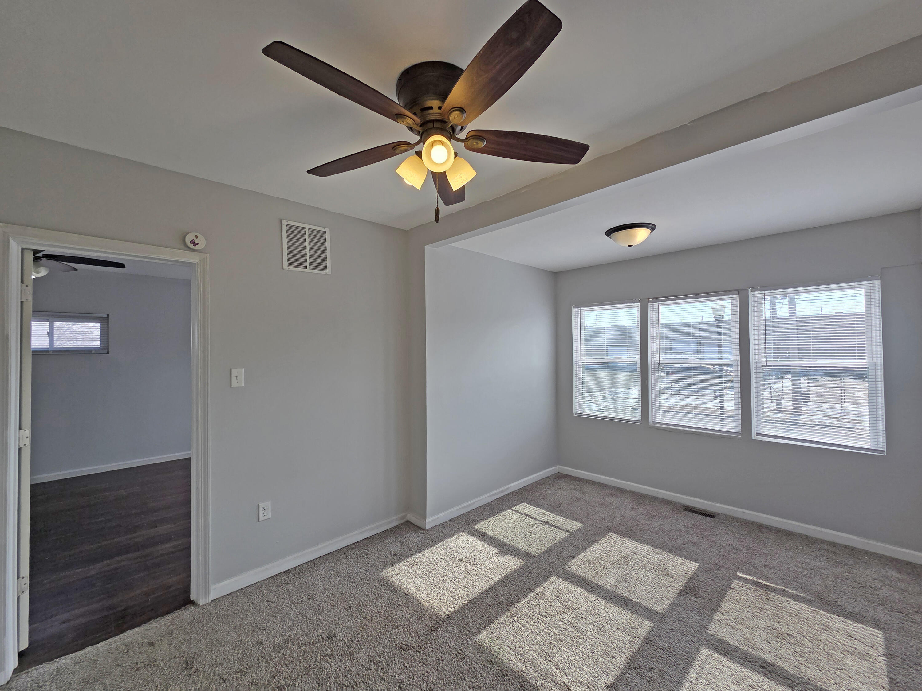 1127 164th Place Hammond, IN 46320 - Photo 19 of 34 a view of an empty room with window and chandelier fan