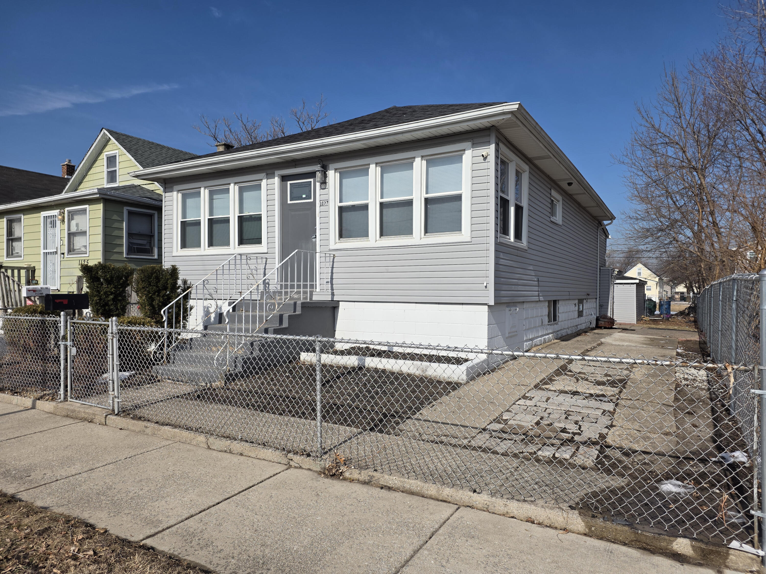 1127 164th Place Hammond, IN 46320 - Photo 2 of 34 a front view of a house with a patio