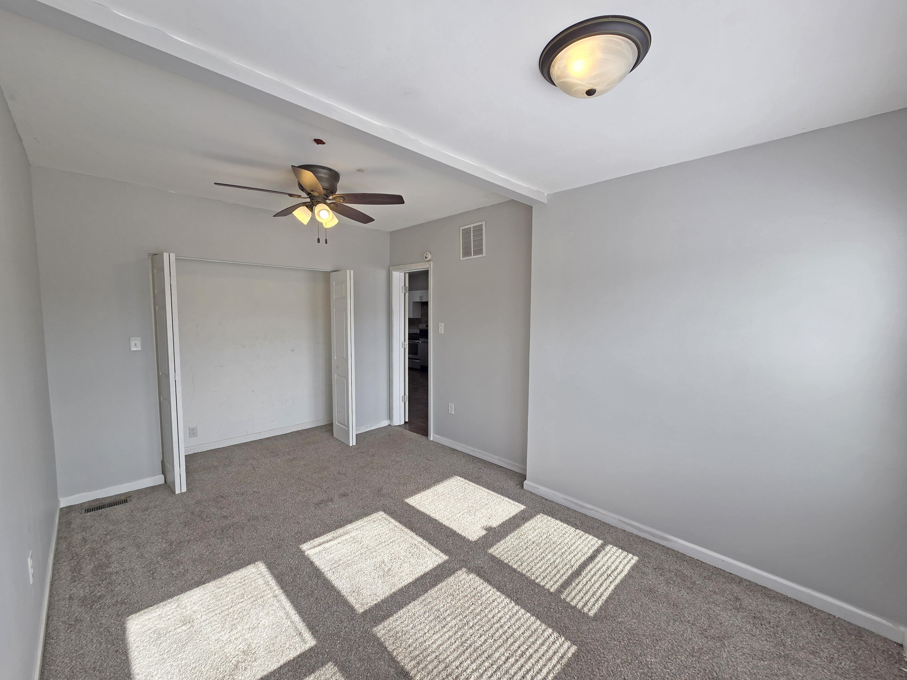 1127 164th Place Hammond, IN 46320 - Photo 21 of 34 an empty room with fan and windows