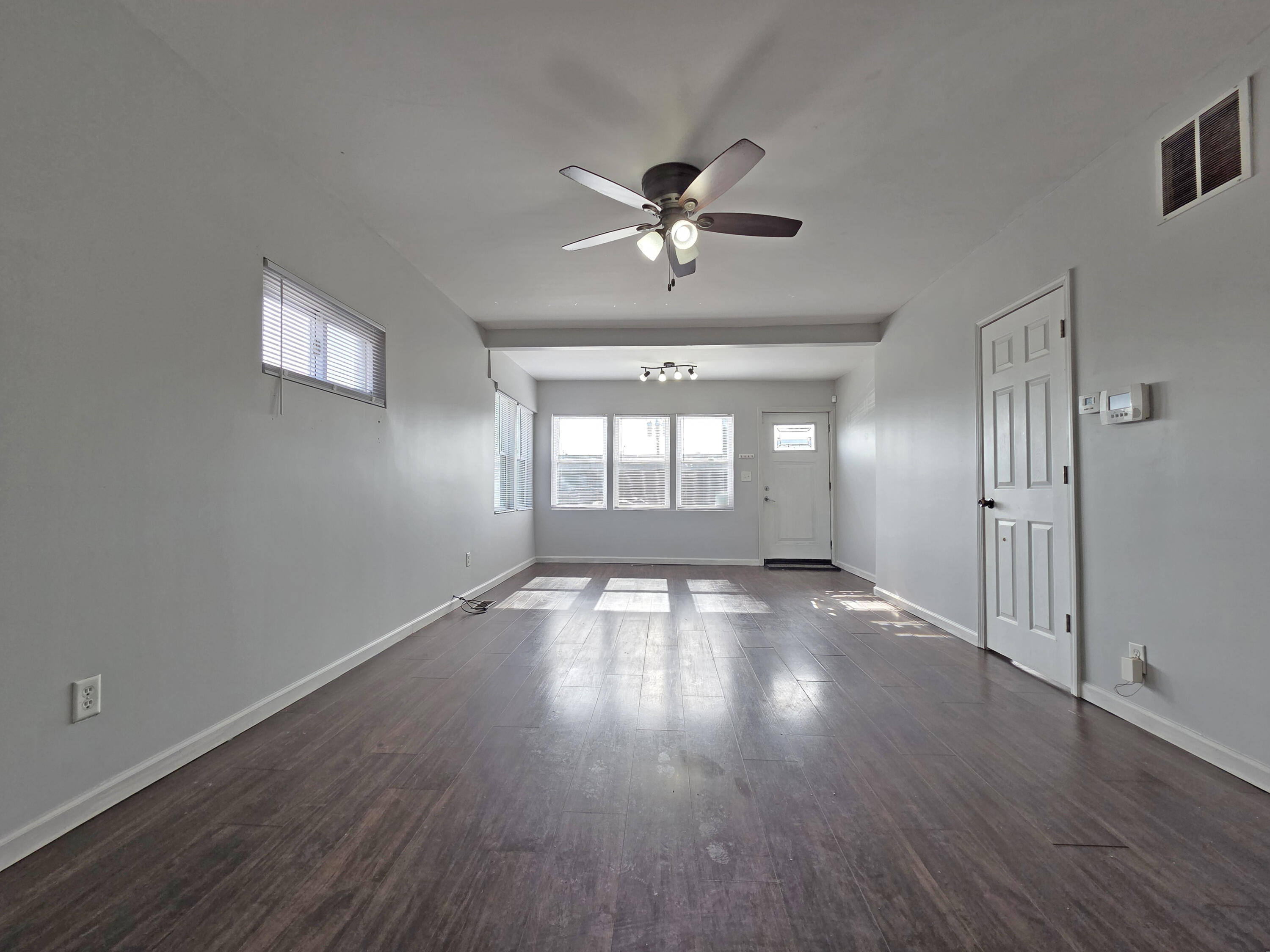 1127 164th Place Hammond, IN 46320 - Photo 7 of 34 a view of empty room with wooden floor and fan