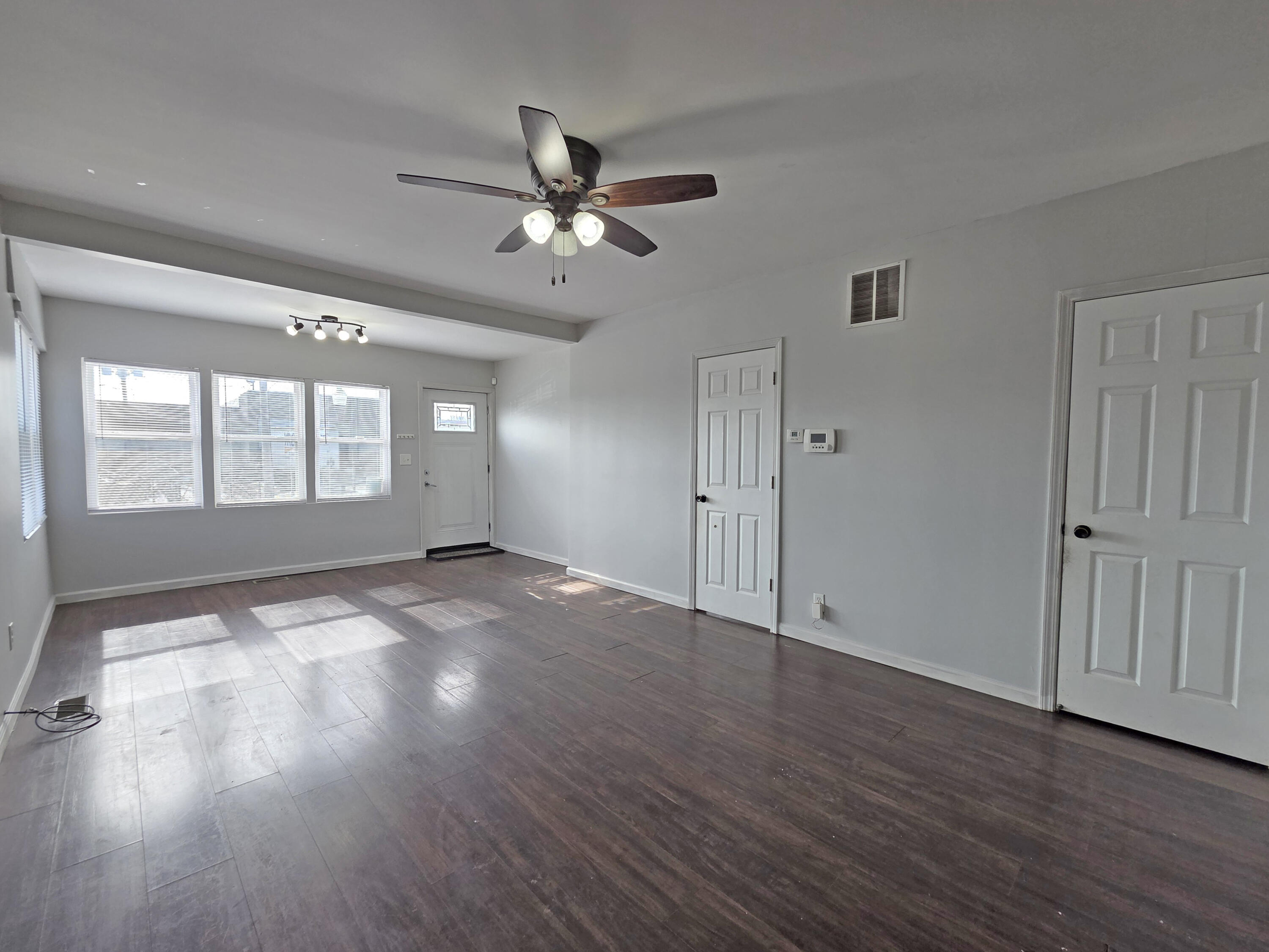 1127 164th Place Hammond, IN 46320 - Photo 8 of 34 a view of empty room with wooden floor and fan