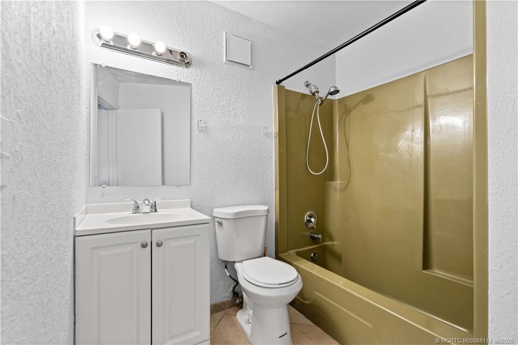 2118 Southeast Edler Drive, Unit B Stuart, FL 34994 - Photo 13 of 20 a bathroom with a sink a toilet and shower