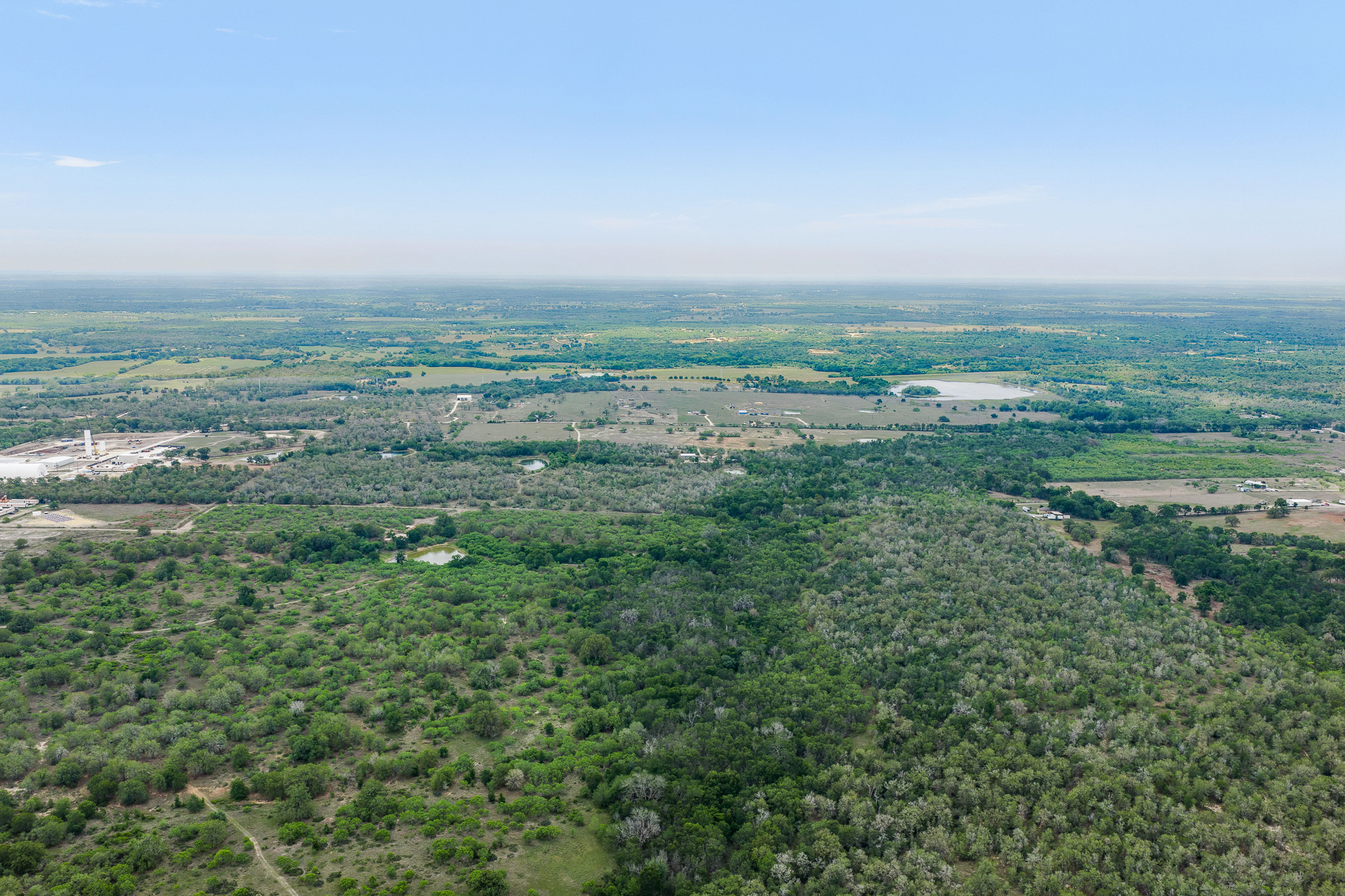 Tbd Lot 30 Tbd Road Lockhart, TX 78644 - Photo 1 of 6 Vast natural landscape provides serene, private surroundings, ideal for a tranquil escape.