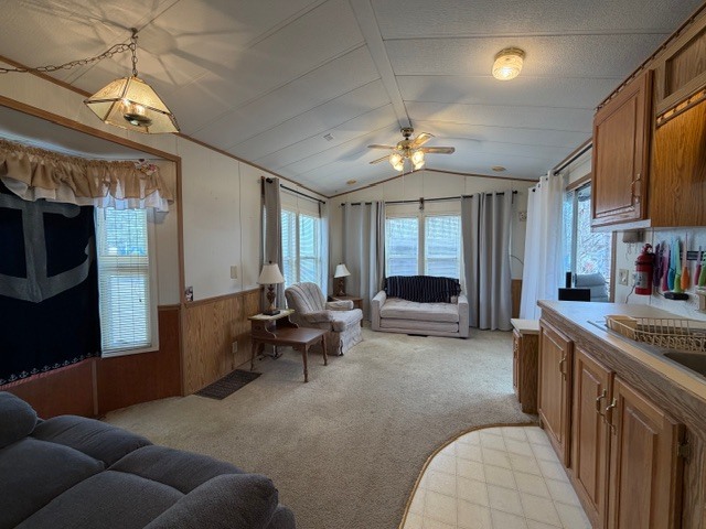 2795 East 28th Road Marseilles, IL 61341 - Photo 13 of 69 a living room with furniture a chandelier and a flat screen tv