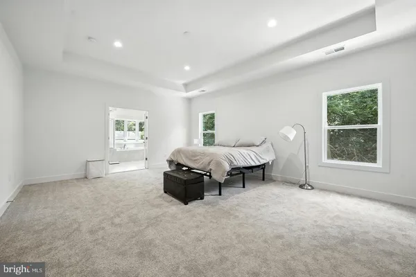 a spacious bedroom with a bed and a window