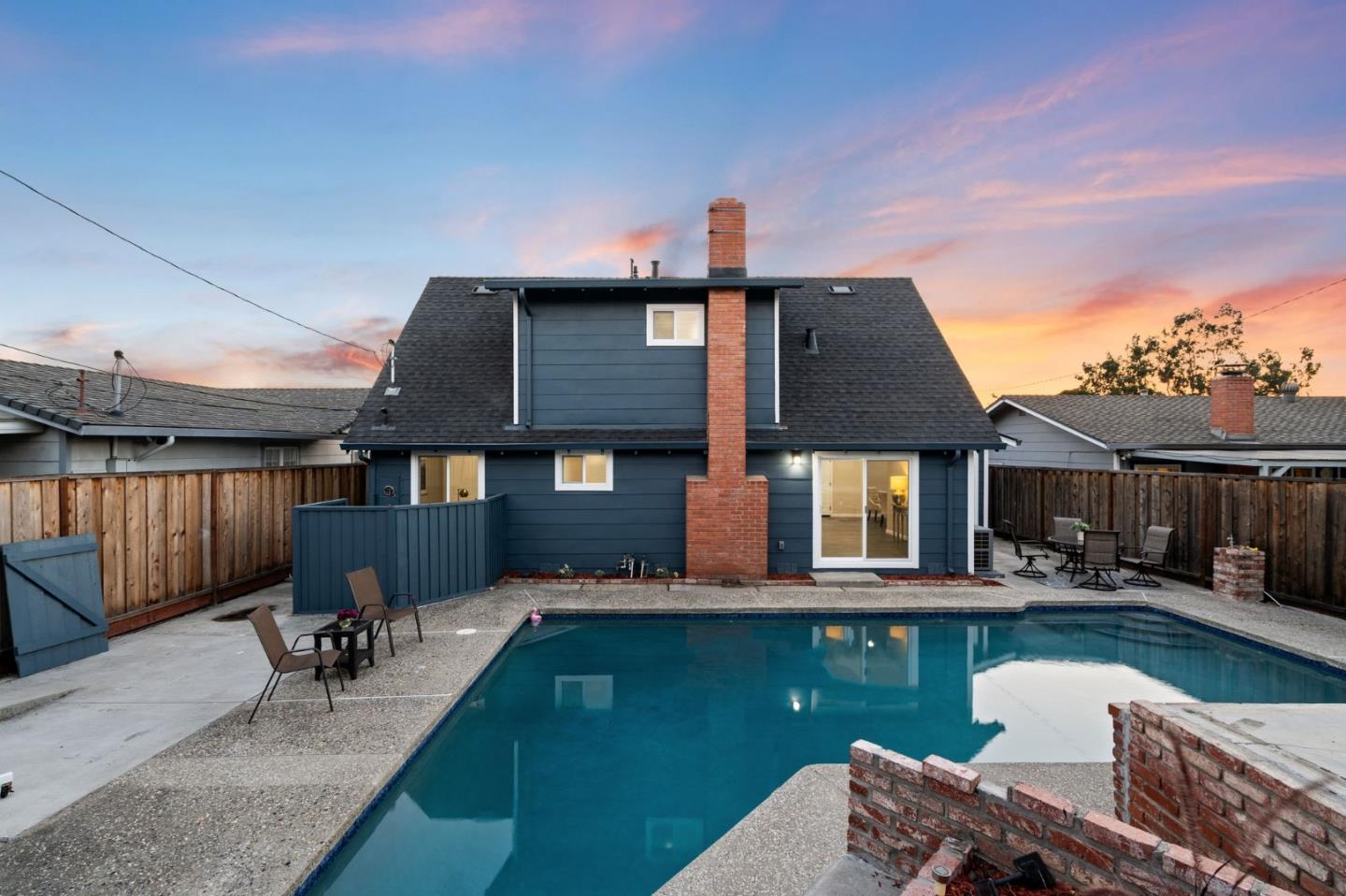 2178 Corktree Lane San Jose, CA 95132 - Photo 31 of 41 a front view of a house with swimming pool table and chairs