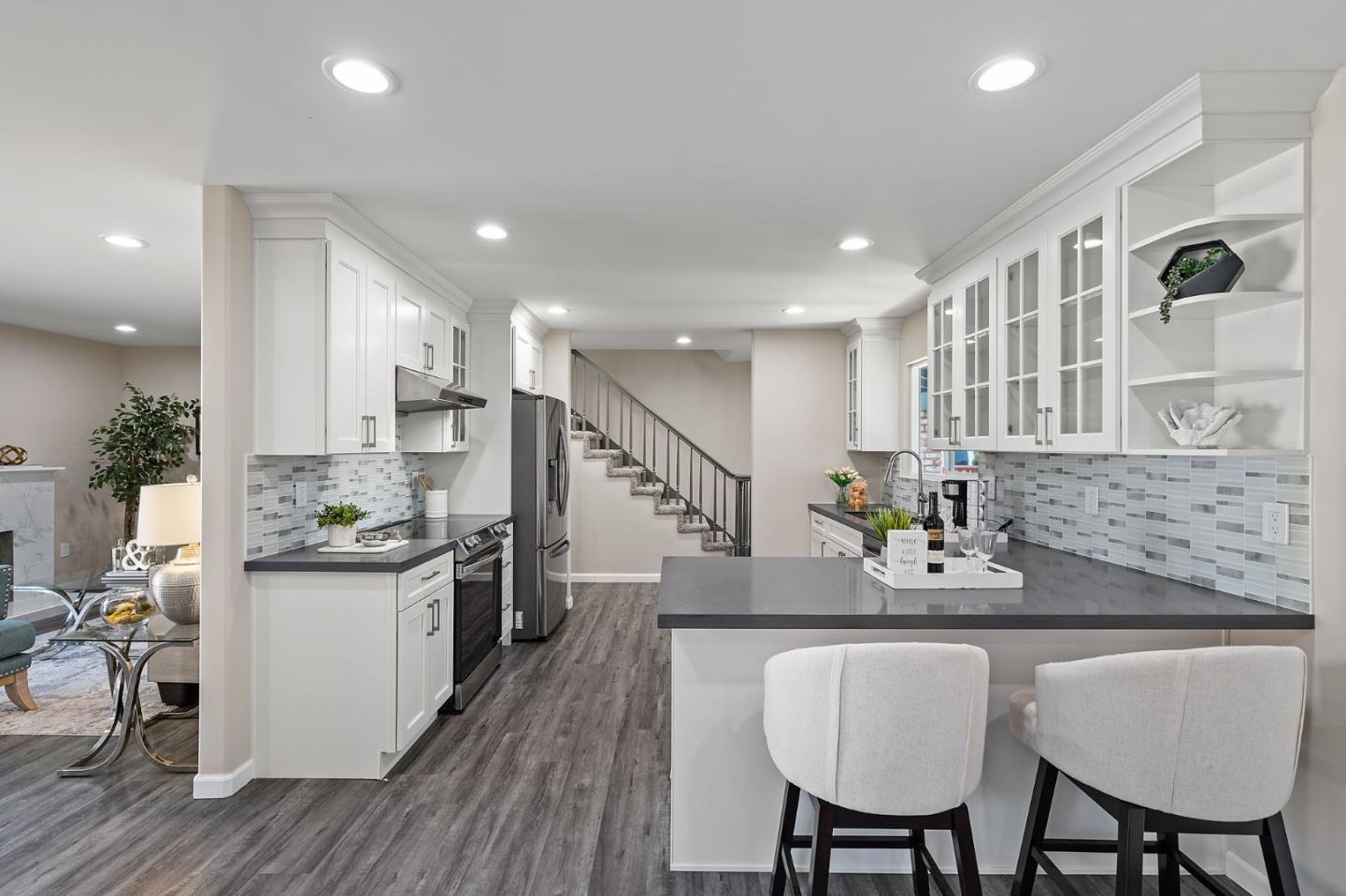 2178 Corktree Lane San Jose, CA 95132 - Photo 8 of 41 a kitchen with stainless steel appliances granite countertop sink wooden floor dining table and chairs
