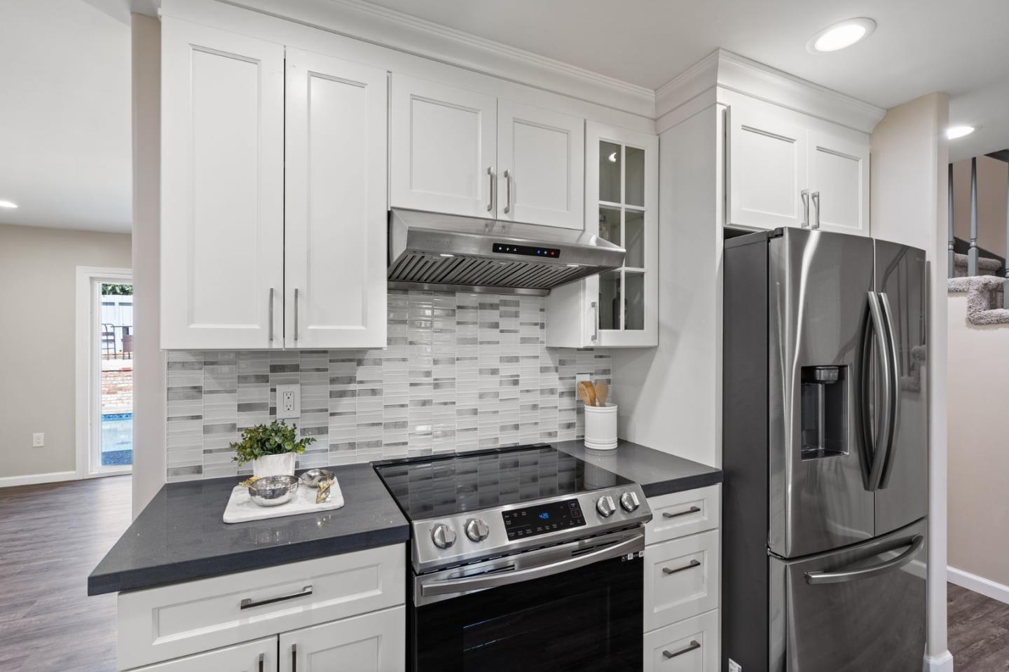 2178 Corktree Lane San Jose, CA 95132 - Photo 9 of 41 a kitchen with stainless steel appliances a refrigerator a stove a sink and cabinets