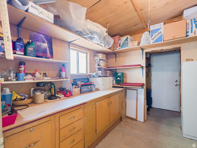 3941 West 40 North Hurricane, UT 84737 - Photo 35 of 55 Utility room featuring built-in cabinetry, extensive shelving, a single window, and a light-colored door