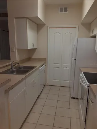 a kitchen with a sink and cabinets