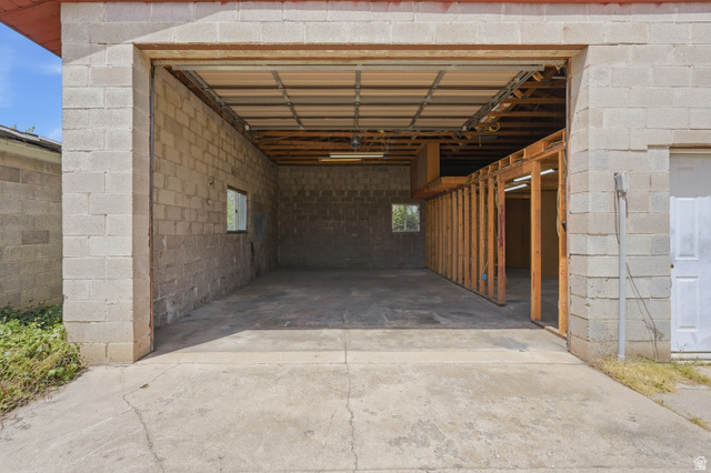 378 West 200 South Bountiful, UT 84010 - Photo 26 of 32 Spacious block construction garage featuring a concrete floor, exposed ceiling joists, and framed interior partitions