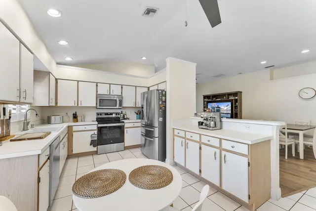 a kitchen with a sink stove and refrigerator