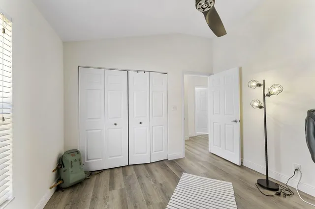 a view of a room with wooden floor and bathroom