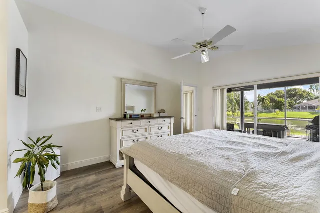 a bed sitting in a bedroom next to a window with outer view