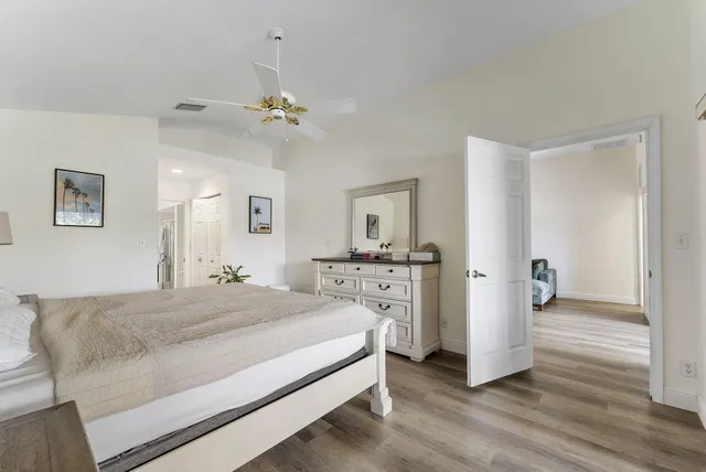 a spacious bedroom with a bed and a chandelier