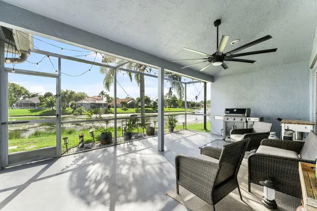 a living room with a floor to ceiling window and a table