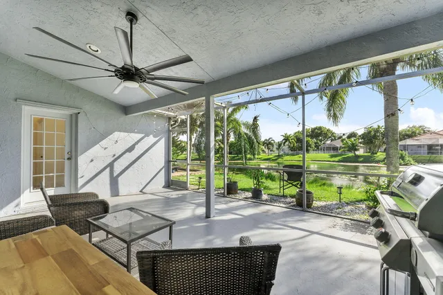 a living room with a floor to ceiling window and a table